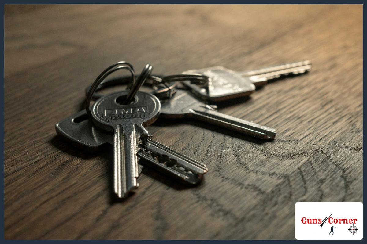 Ring of metal keys lying on a wooden table, a reminder to keep gun lock keys away from the gun